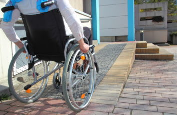 Woman in a wheelchair using a ramp